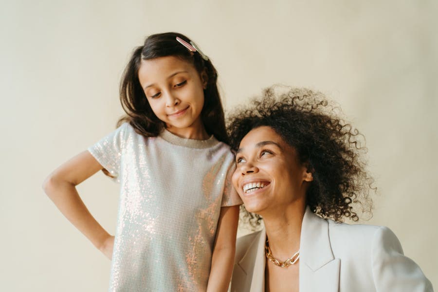 A parent and child smiling together