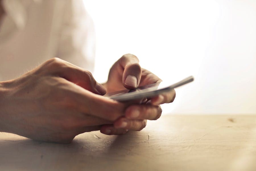 A person keeping in touch with family on a phone
