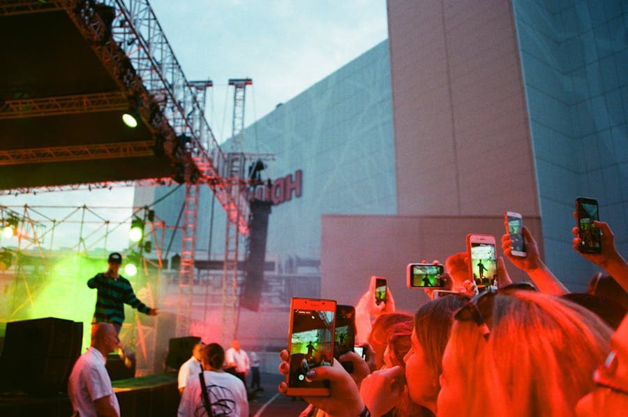 People filming a concert on their phones