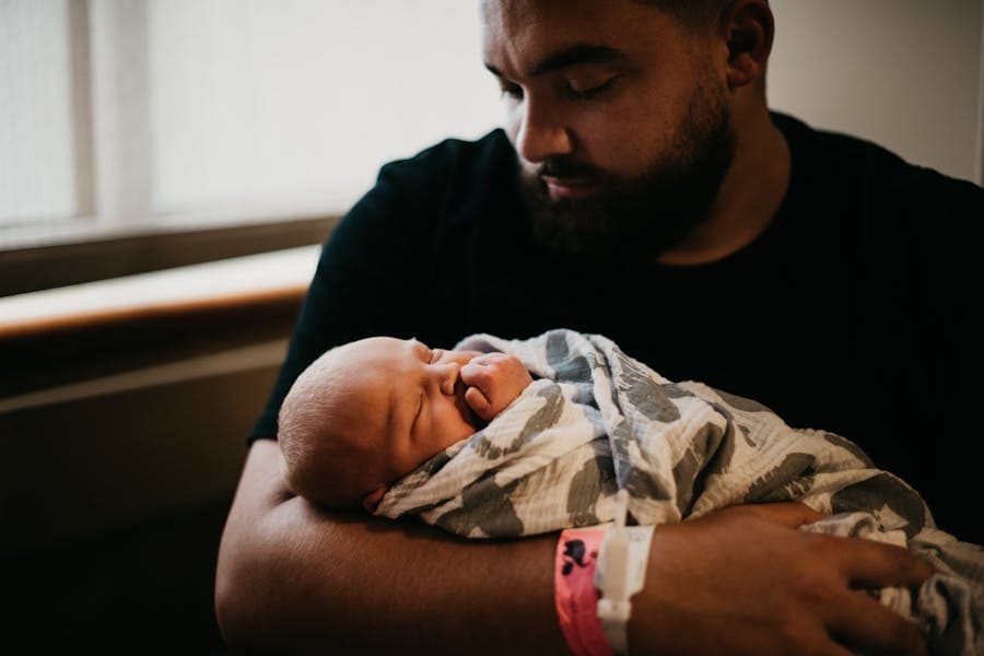 A parent holding their newborn baby