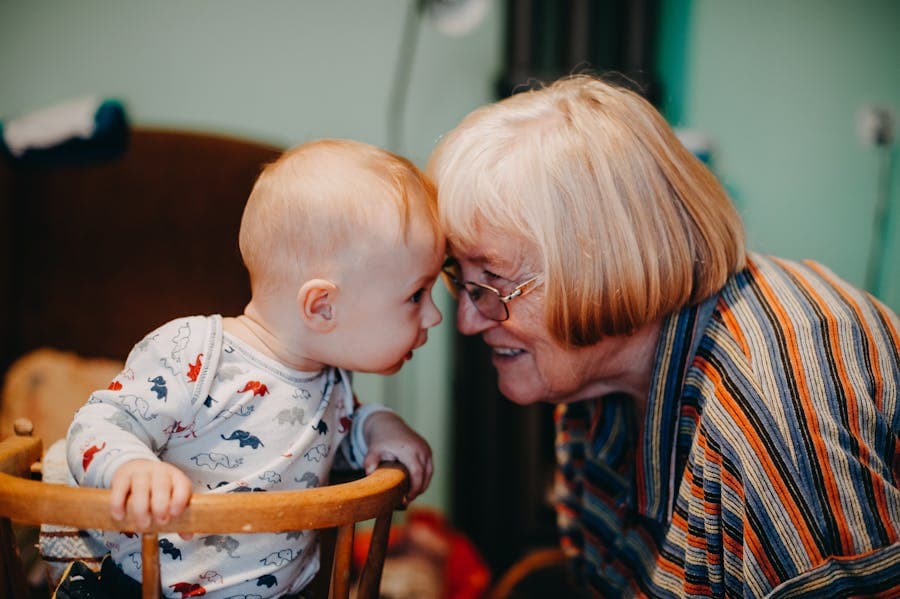 A grandparent smiling with a baby