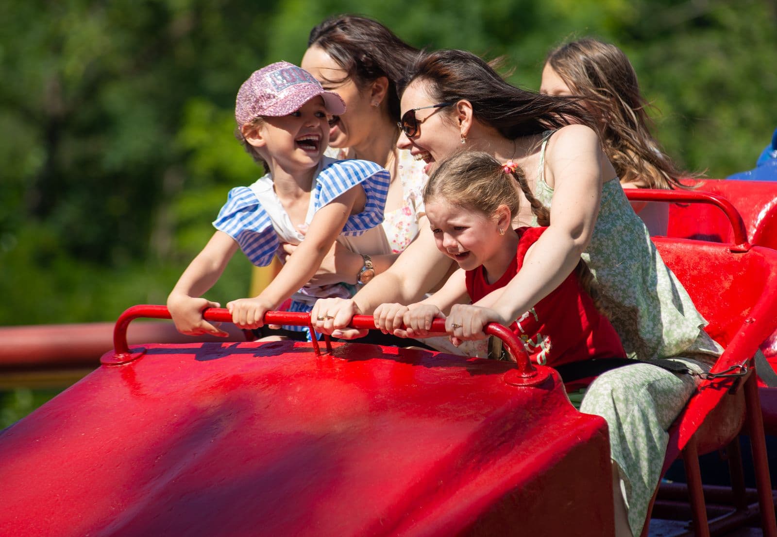 A family laughing together on a theme park ride