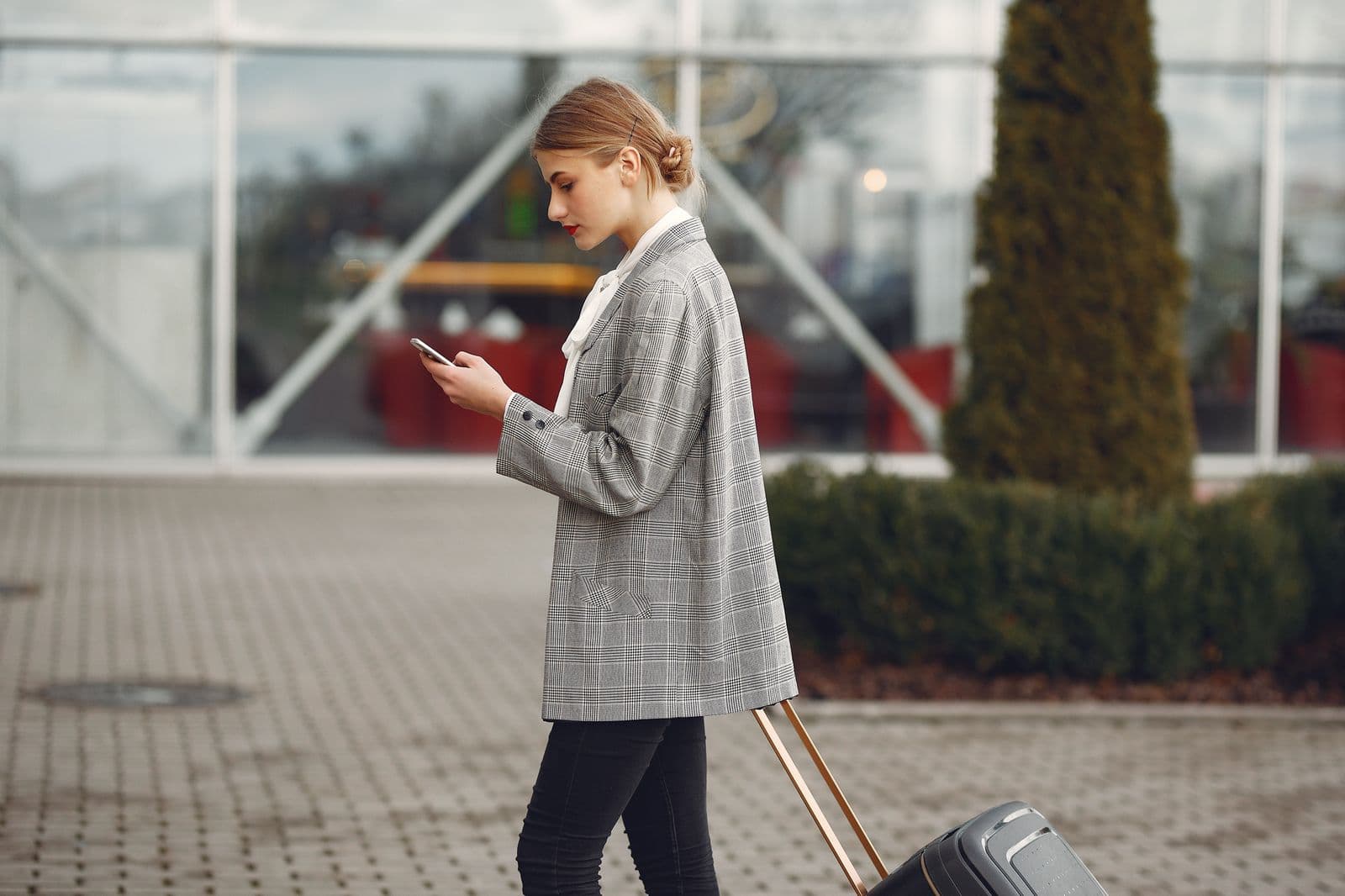 A person messaging family on a phone in a new city