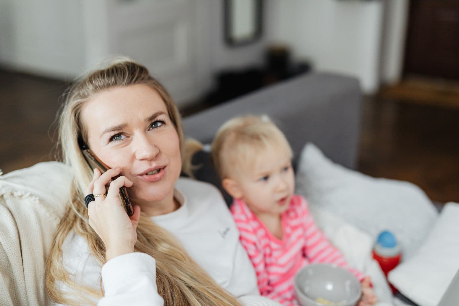 A person smiling at family photos on their phone