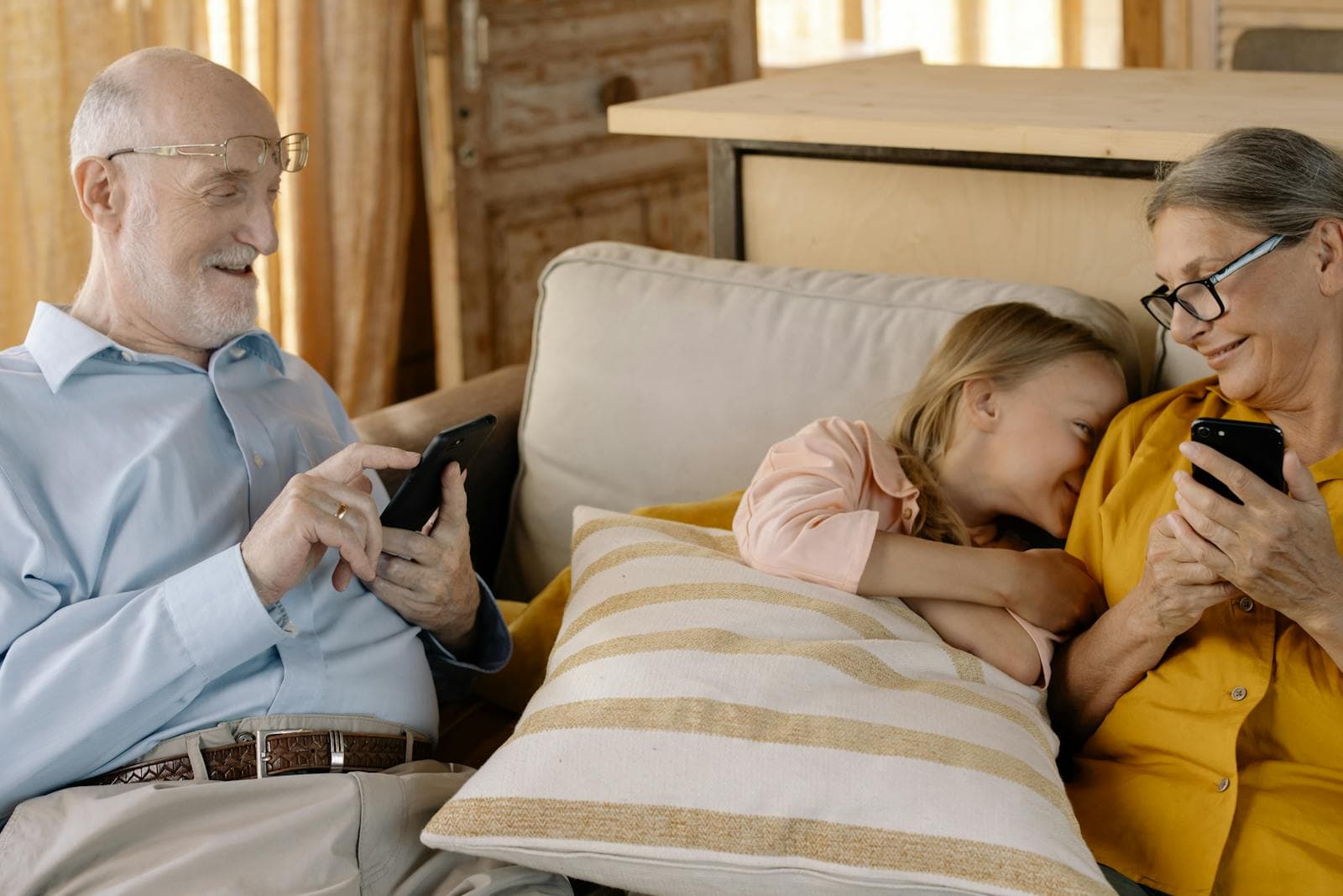 Grandparents smiling while looking at photos on a phone