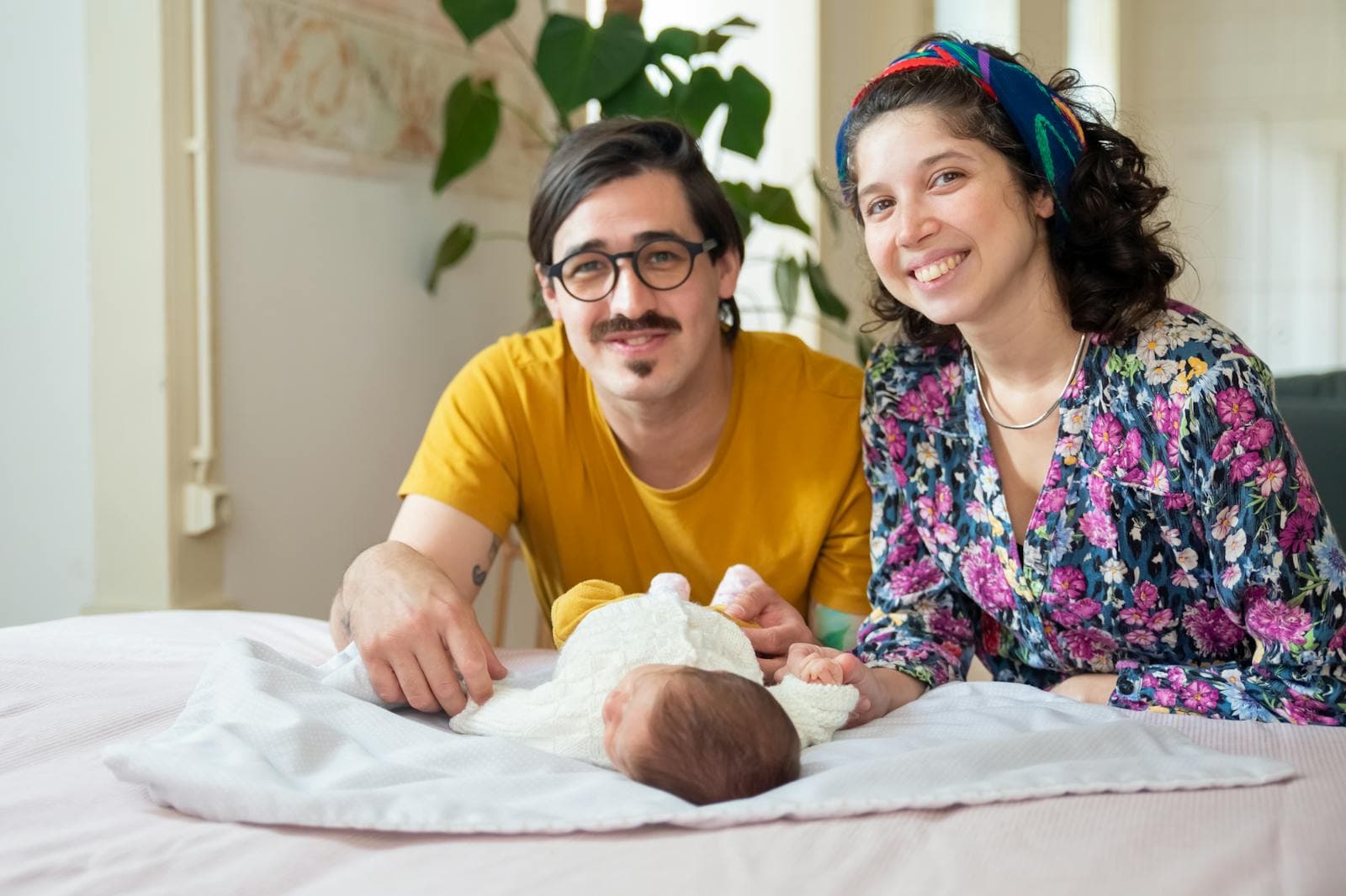 A parent cuddling their newborn baby